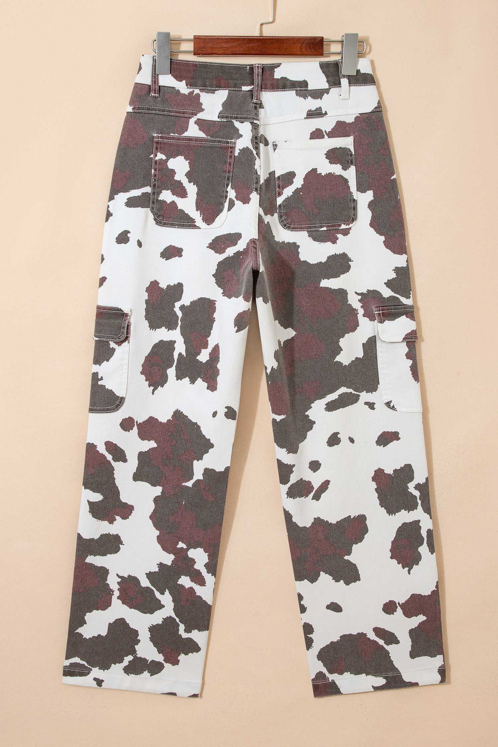 Brown Cow Print multi-pocket jeans in cotton-blend fabric with a brown and white cow-spot pattern and cargo pockets.
