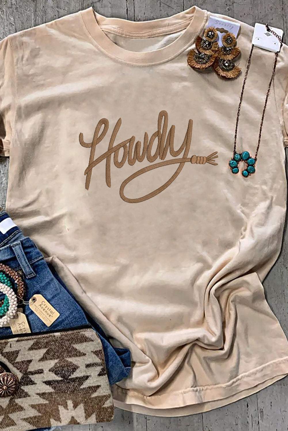 Khaki Howdy Embroidered Western Tee with tan khaki color, embroidered "Howdy" lettering, and short sleeves in soft cotton blend fabric