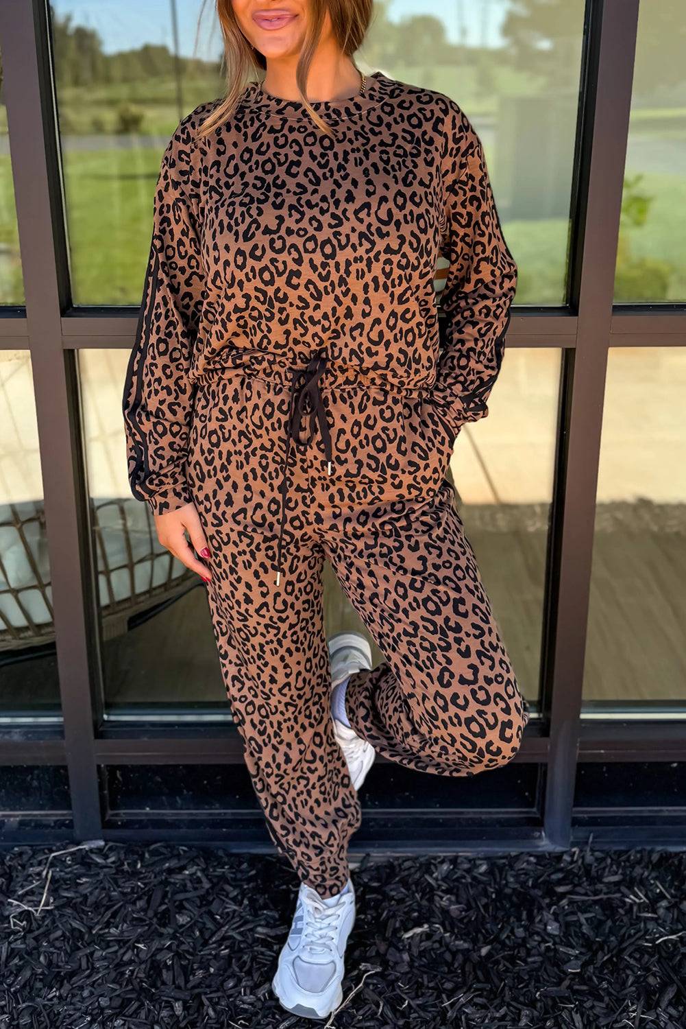Brown Leopard Varsity two-piece set with black jogger pants and top featuring leopard print and varsity stripes on sleeves