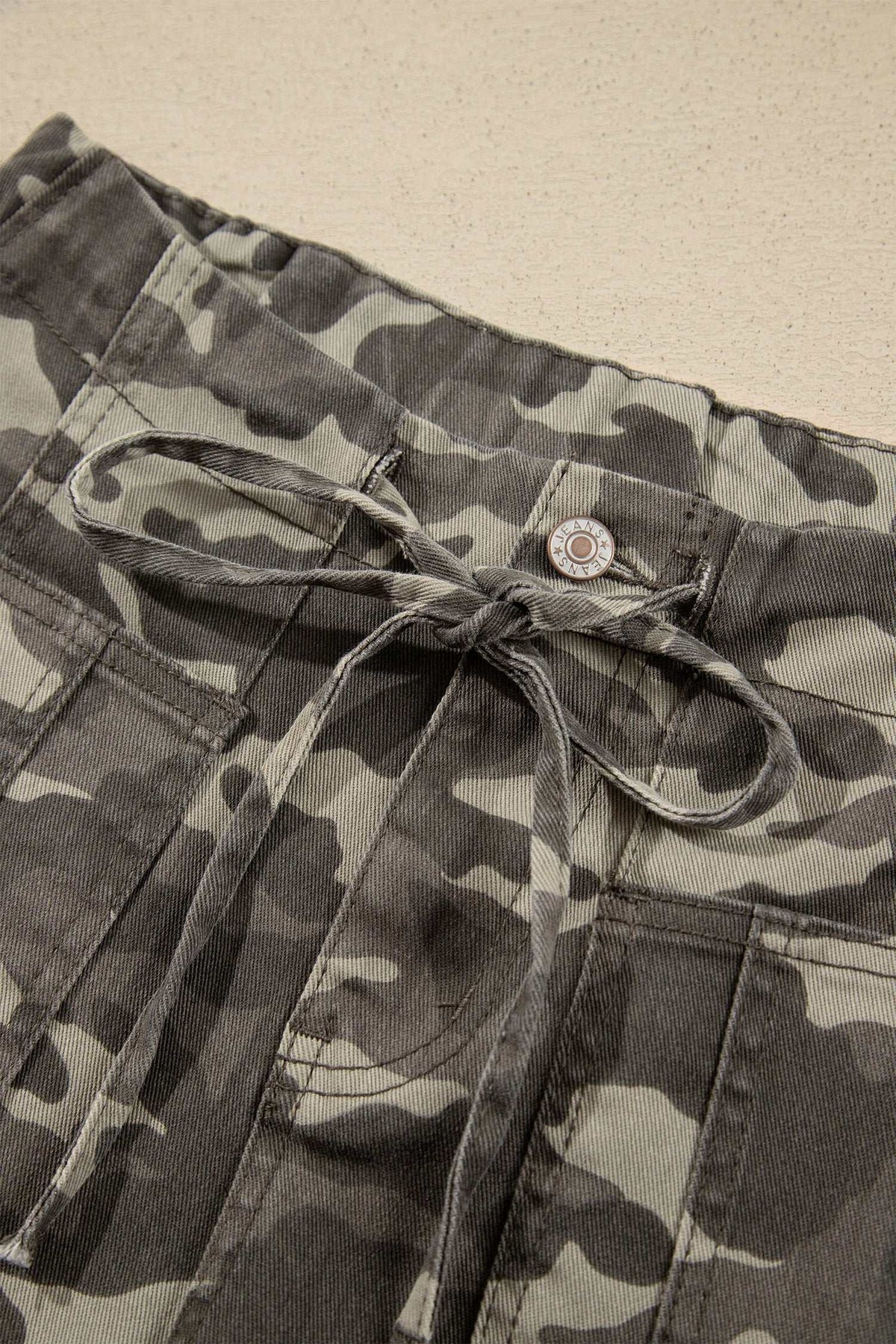 Khaki Leopard Drawstring barrel-fit jeans with elastic waist, camouflage pattern, front pockets, and drawstring tie closure.