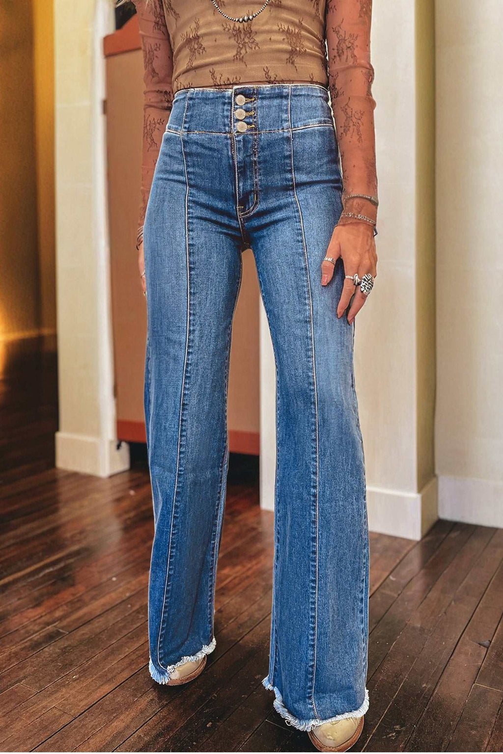 Flared denim jeans with panel detailing, button fly, and raw hem, styled with a Coffee High Waist silhouette.
