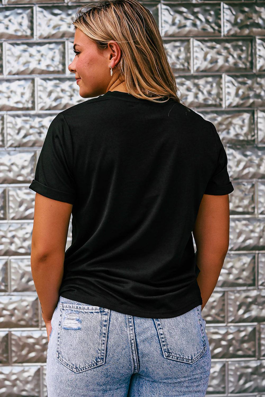 Black Rhinestone Western Graphic Tee in black cotton blend featuring a rhinestone western design and short sleeves worn by a woman