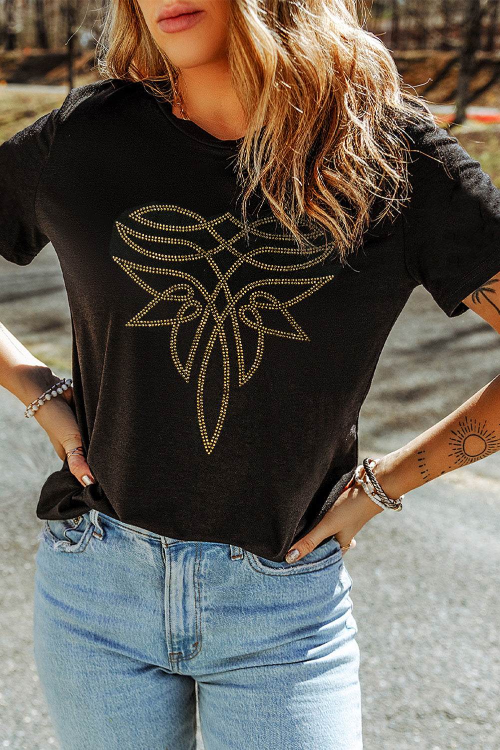 Black Rhinestone Western Graphic Tee featuring gold rhinestone tribal pattern on soft black cotton blend fabric.