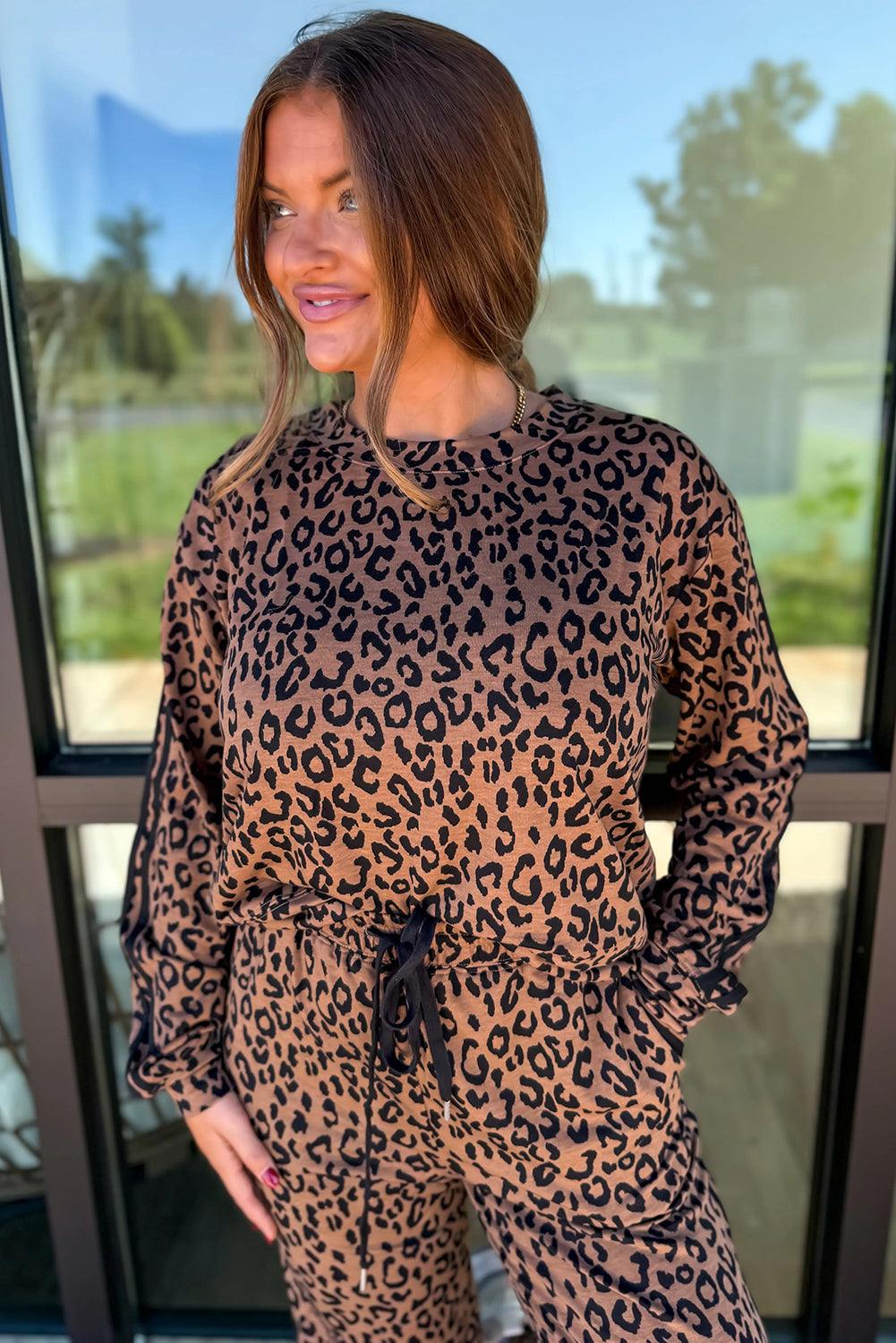 Brown Leopard Varsity two-piece set with black drawstring jogger pants and long-sleeve leopard print top in soft fabric.
