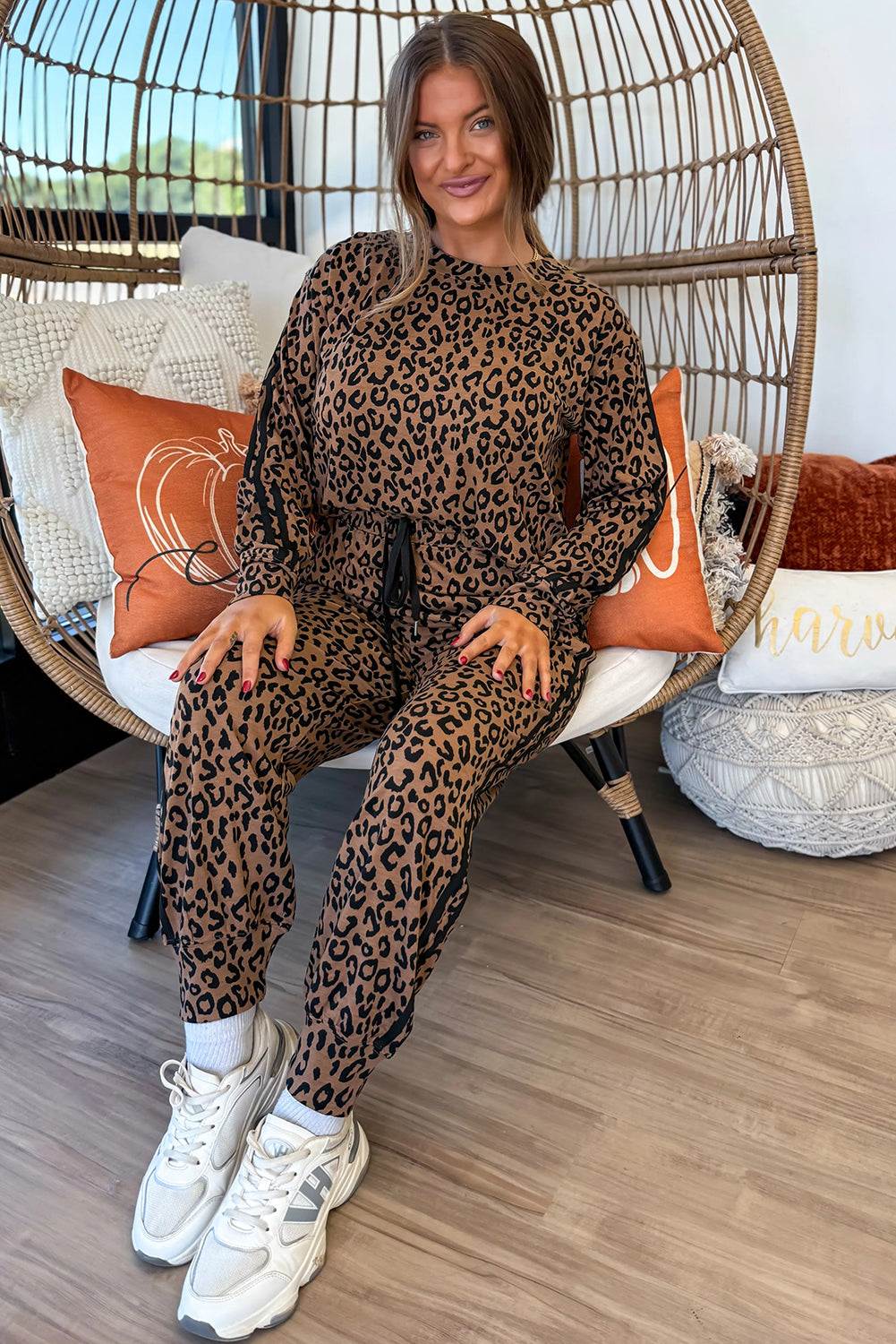 Brown Leopard Varsity two-piece set with leopard print, long sleeves, drawstring jogger pants, and black varsity stripes down sleeves and legs