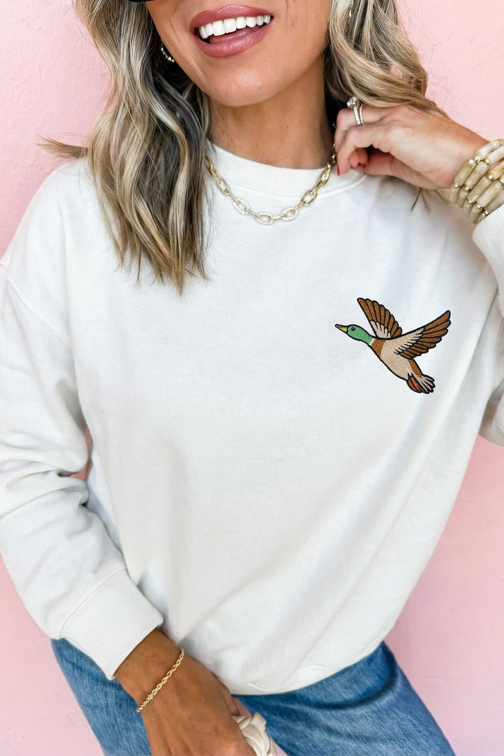 White Mallard relaxed pullover sweatshirt in a soft white cotton-poly blend with embroidered flying mallard duck design