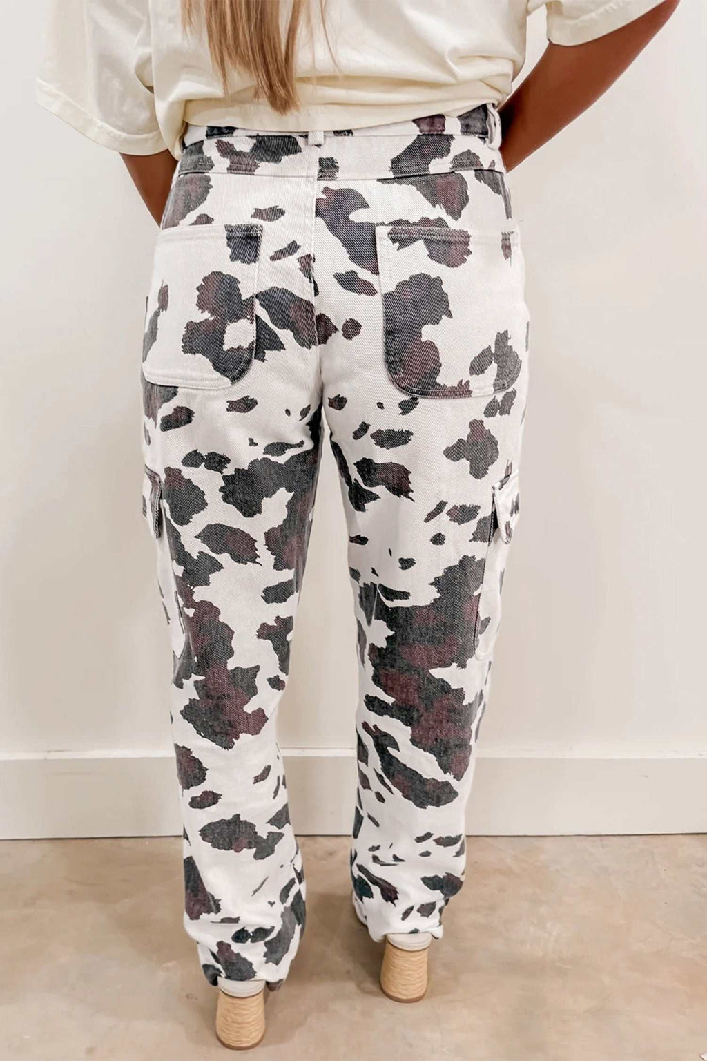 Jeans featuring a Brown Cow Print with multiple rear pockets in a relaxed fit made from cotton-blend fabric with stretch.