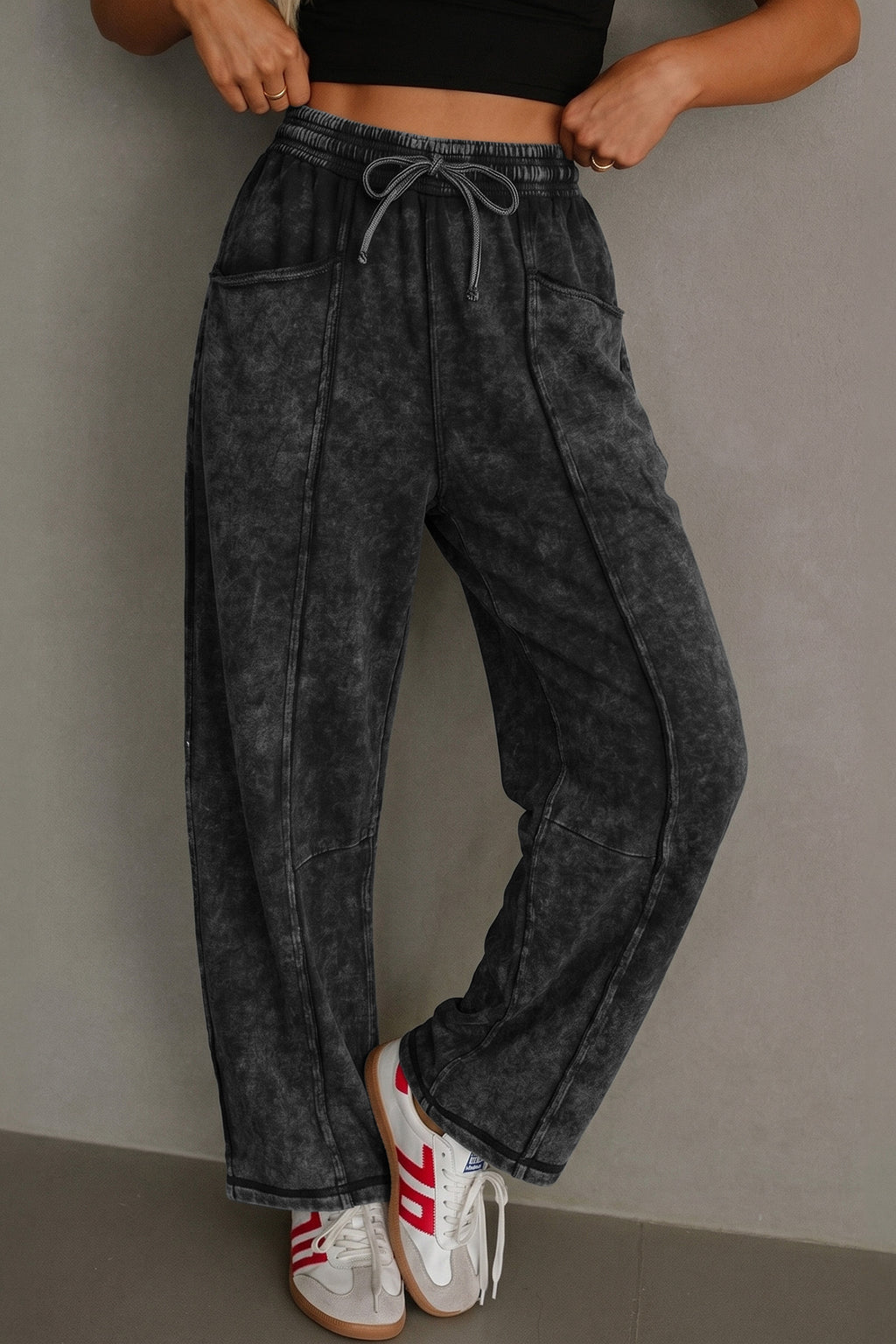 Women's black mineral wash barrel pants with raw seams and drawstring