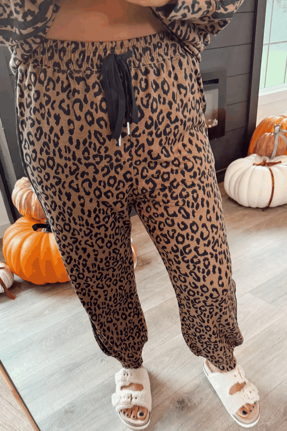 Brown Leopard Varsity jogger pants in brown leopard print with black drawstring and ankle cuffs for casual wear.