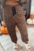 Brown Leopard Varsity jogger pants in brown leopard print with black drawstring and ankle cuffs for casual wear.