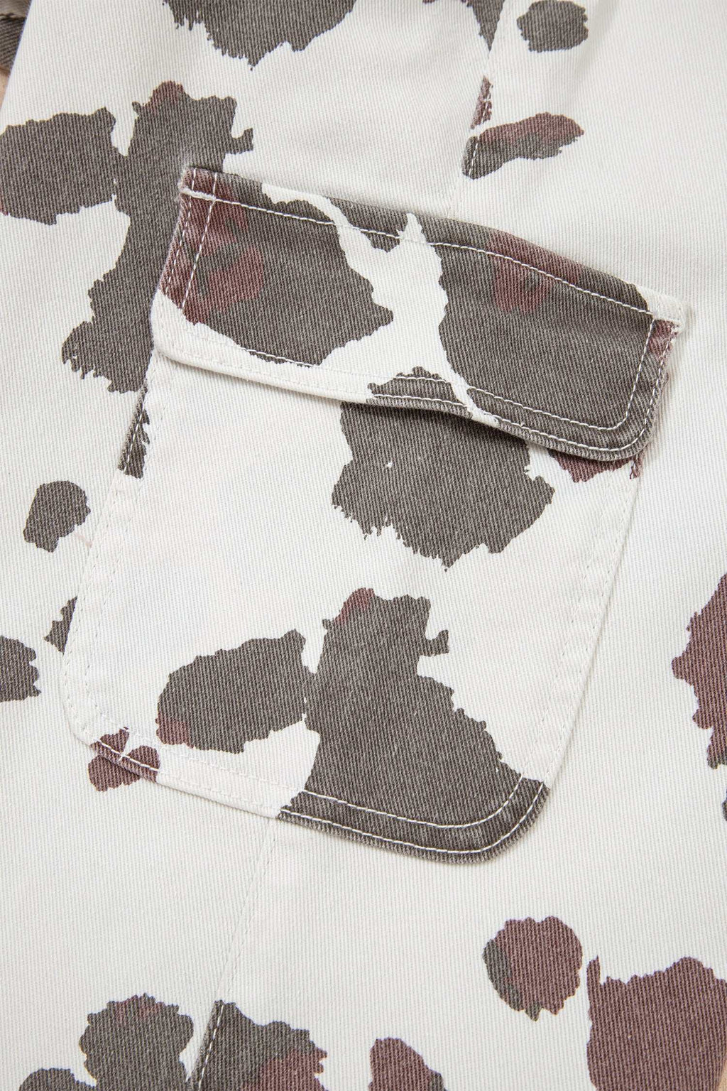 Cotton-blend jeans pocket with Brown Cow Print pattern featuring brown and white cow spots and flap detail
