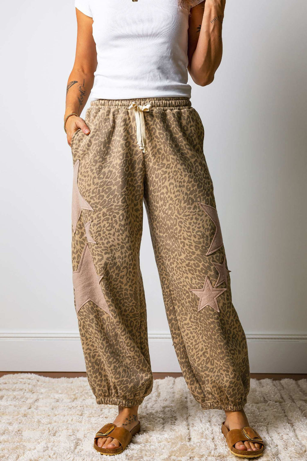 Women's khaki leopard jogger pants with star patches and drawstring waist