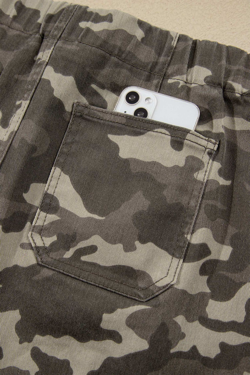 Khaki Leopard Drawstring relaxed-fit jeans featuring an elastic waistband, side pockets, and a camouflage-style leopard print pattern.