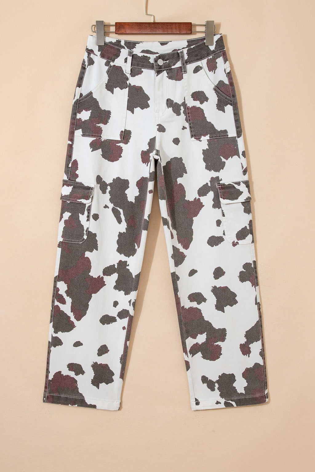 Multi-pocket jeans featuring a Brown Cow Print pattern on white cotton-blend fabric with stretch and utility pockets.