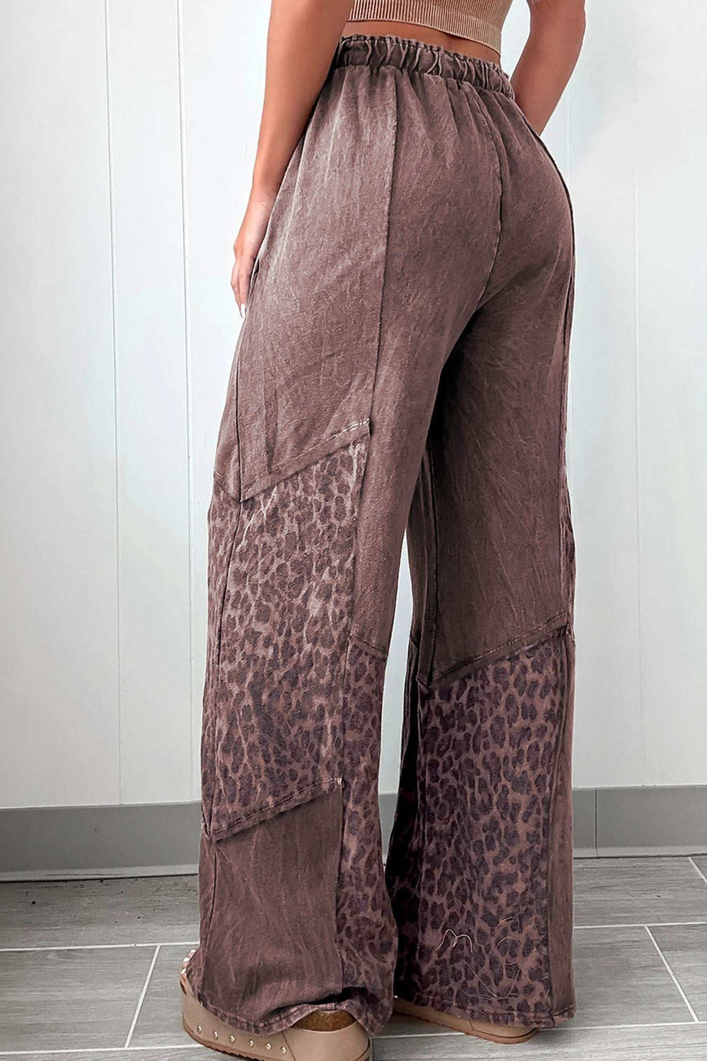 Loose coffee leopard patchwork pants with mineral wash fabric, elastic waistband, and wide-leg silhouette.