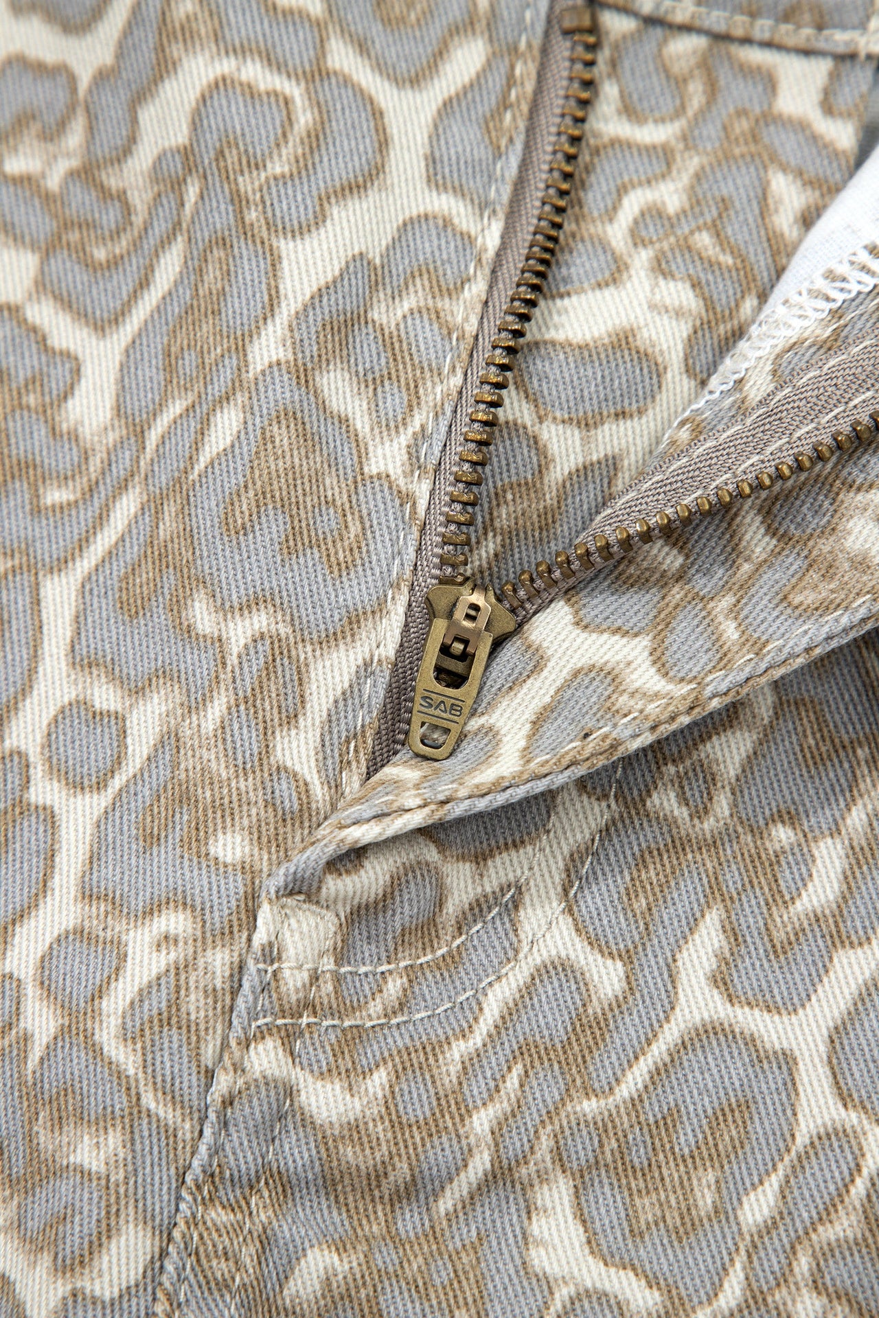 Khaki raw edge leopard print denim shorts with bold raw hems