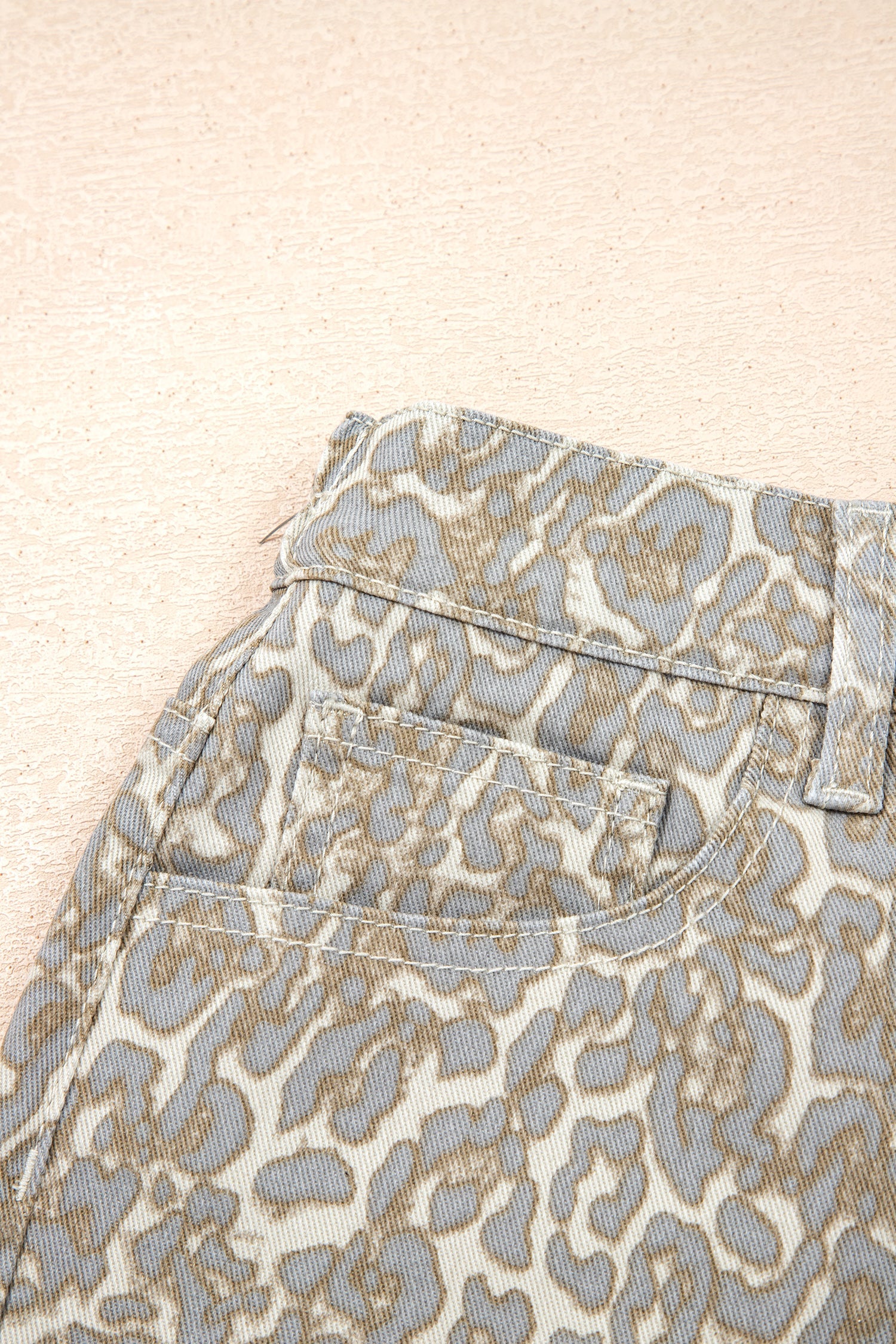 Khaki raw edge leopard print denim shorts with durable fabric and bold design