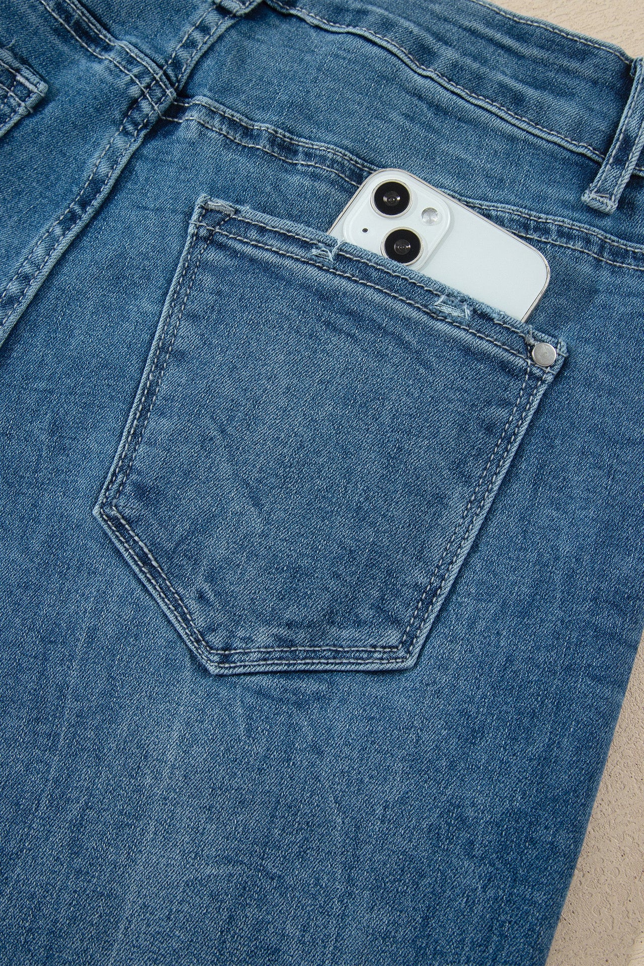 Ashleigh Blue high-waist flare jeans with frayed hems at ankles in classic denim style