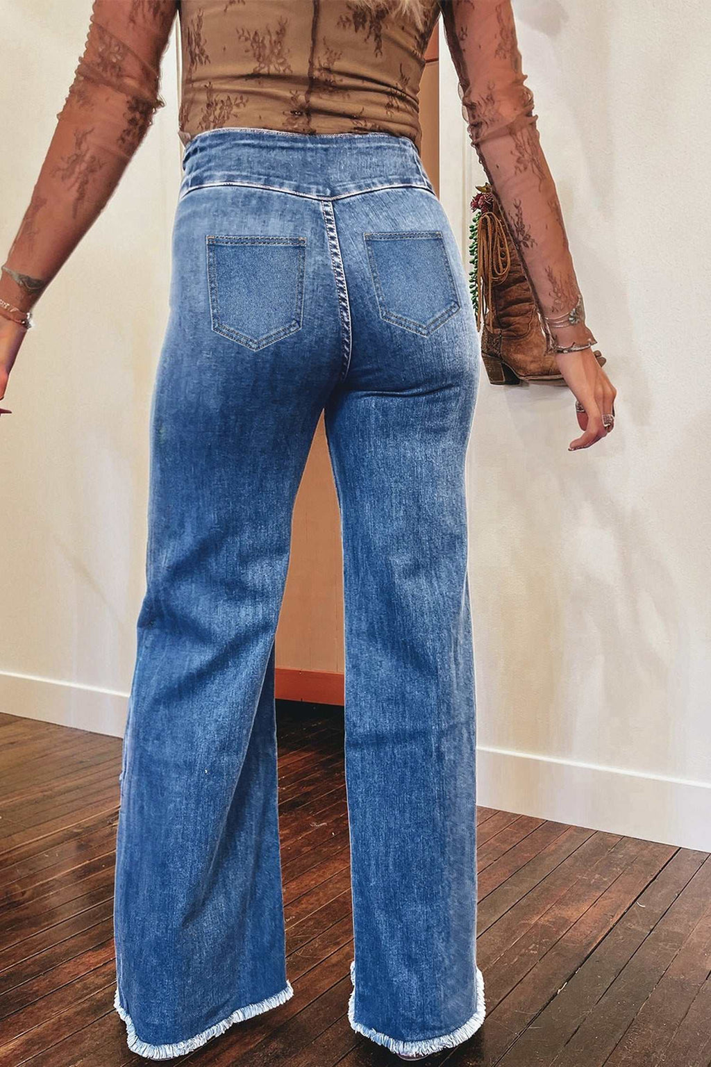 Blue denim high waist flare jeans with raw hem and rear patch pockets, styled with a sheer brown top and handbag, Coffee High Waist.