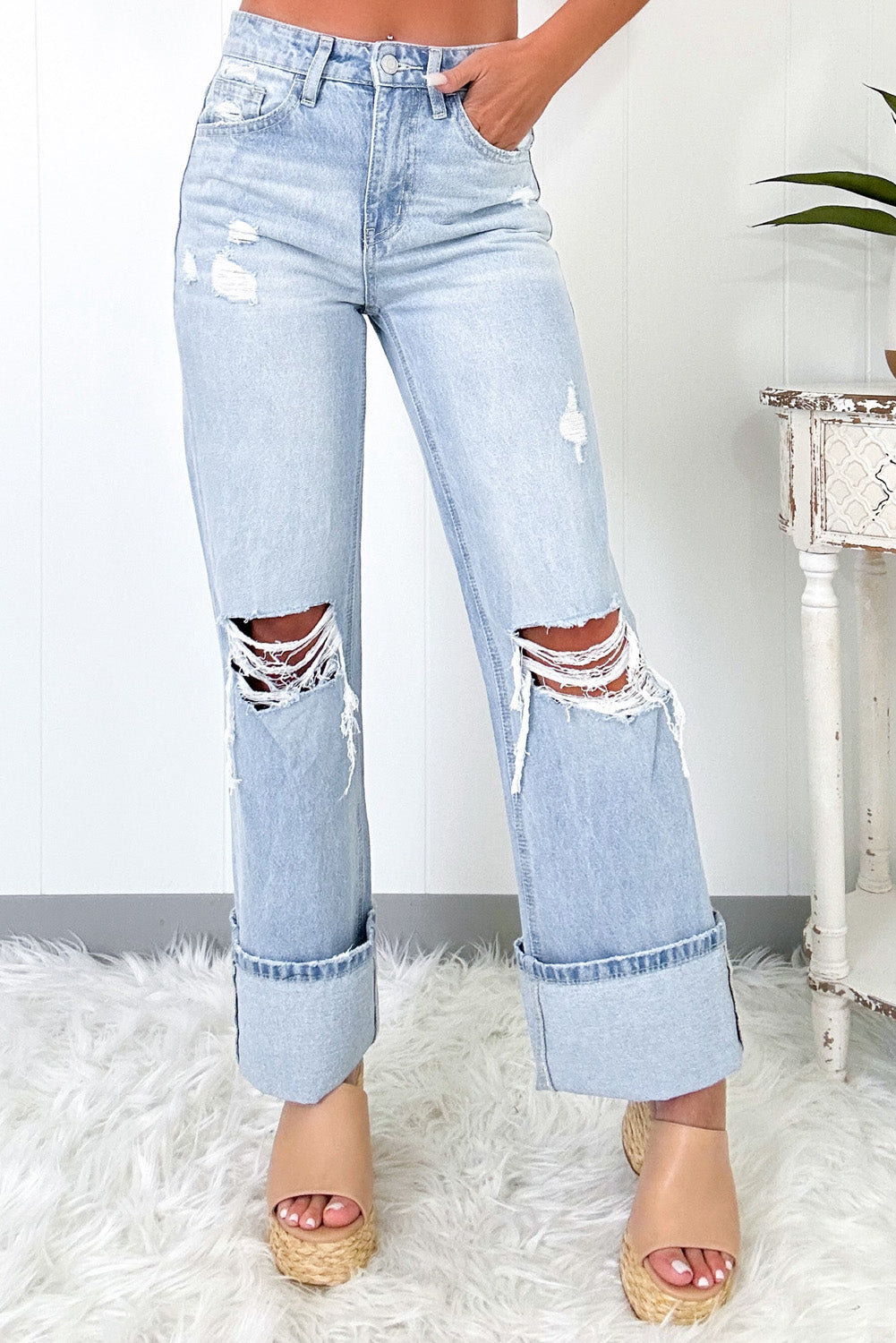 Women's light wash distressed straight jeans with cut-outs