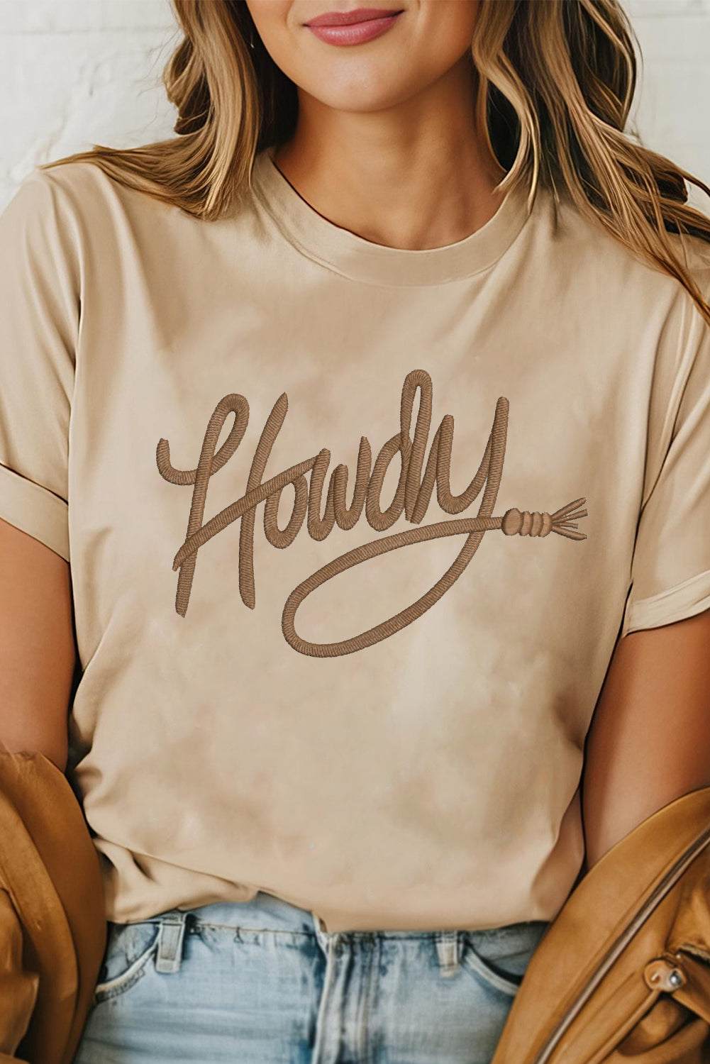 Khaki Howdy Embroidered Western Tee with brown embroidered "Howdy" lettering, cuffed sleeves, and soft cotton blend fabric.