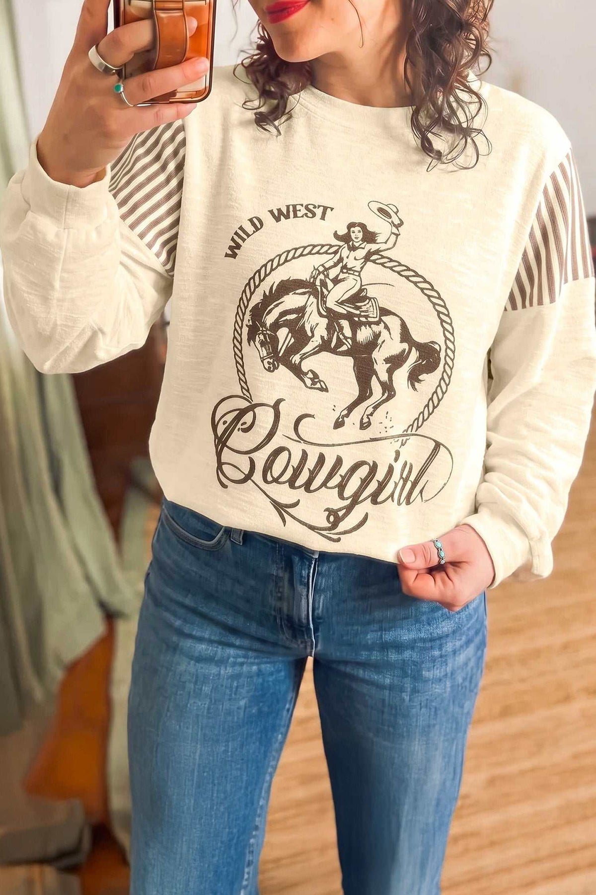 Women's long sleeve top with western print and striped details