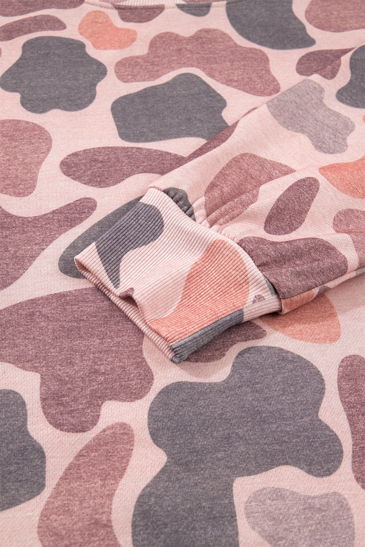 Close-up of a sleeve on the Camo Mock Neck Pullover Sweatshirt in pink, grey, and beige camouflage pattern, highlighting the ribbed cuff and soft fabric texture.