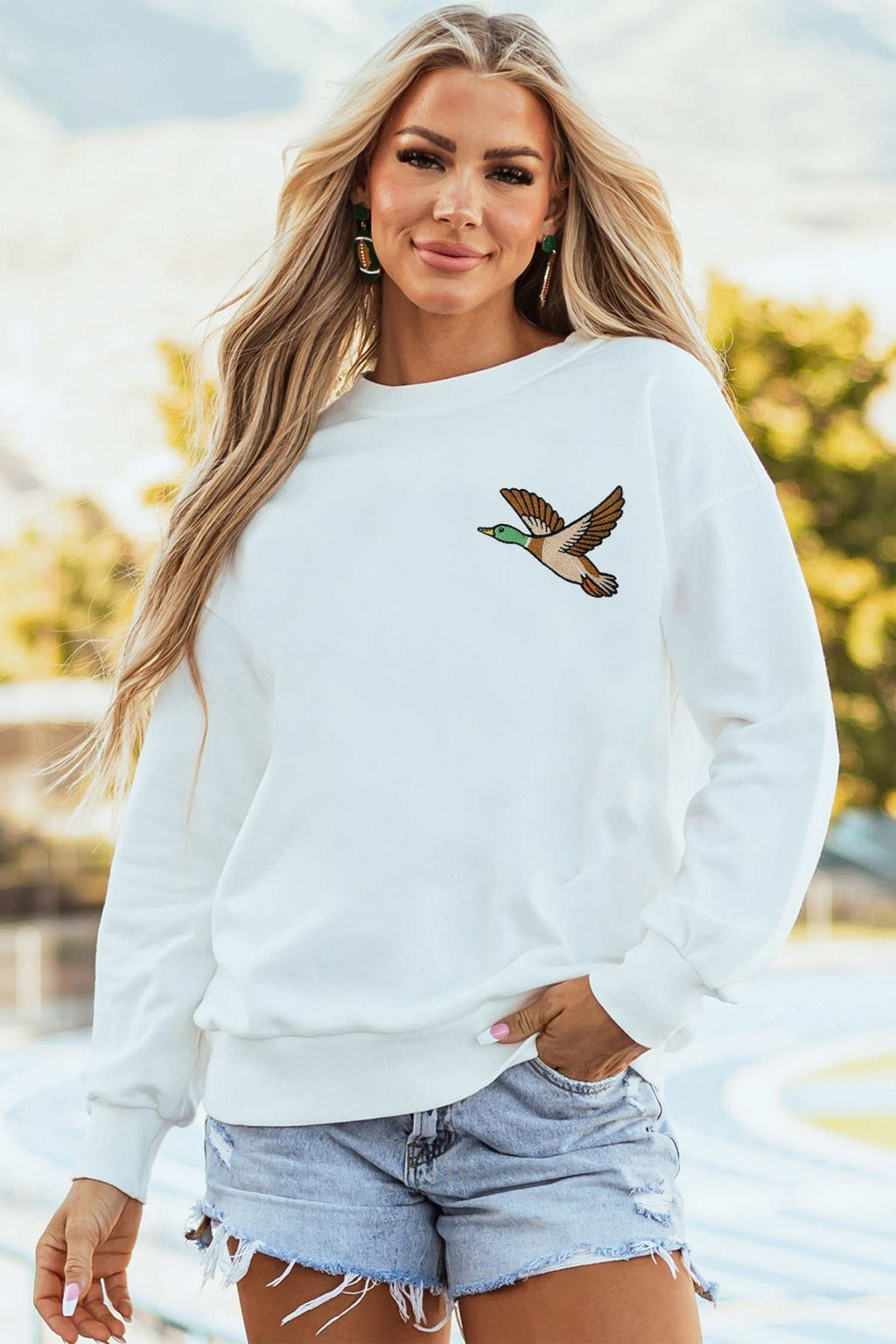 White Mallard relaxed pullover sweatshirt in white cotton blend with embroidered mallard duck on chest and ribbed cuffs