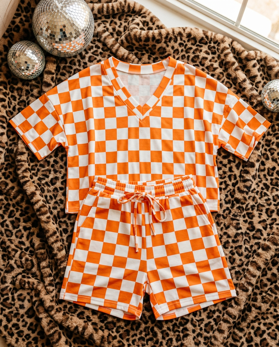 Orange Checkerboard Tee & Shorts Lounge Set flat lay on leopard blanket
