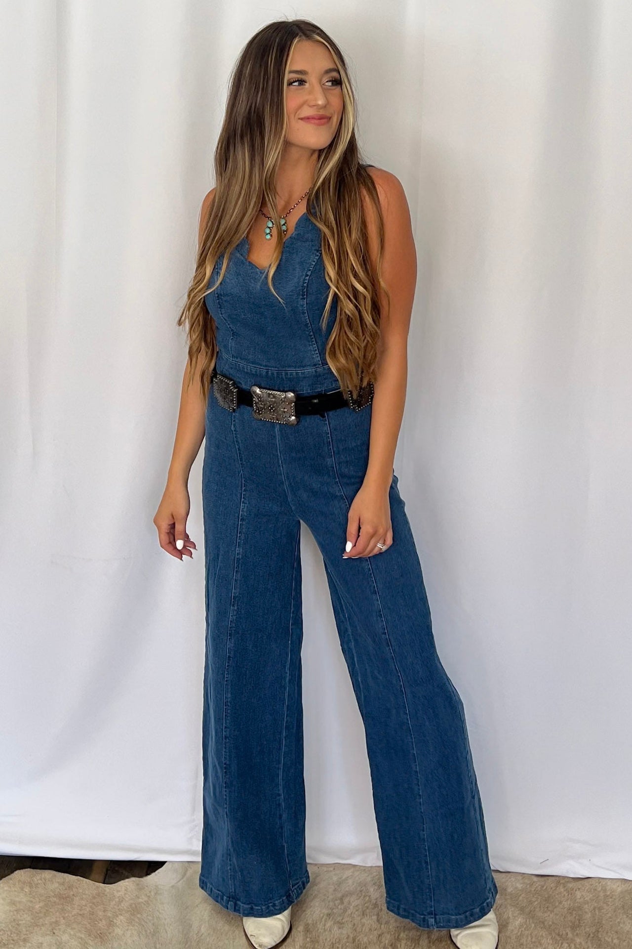 Flying Tomato Rosie washed denim Western jumpsuit with scalloped V-neckline, wide-leg, and banded sash belt
